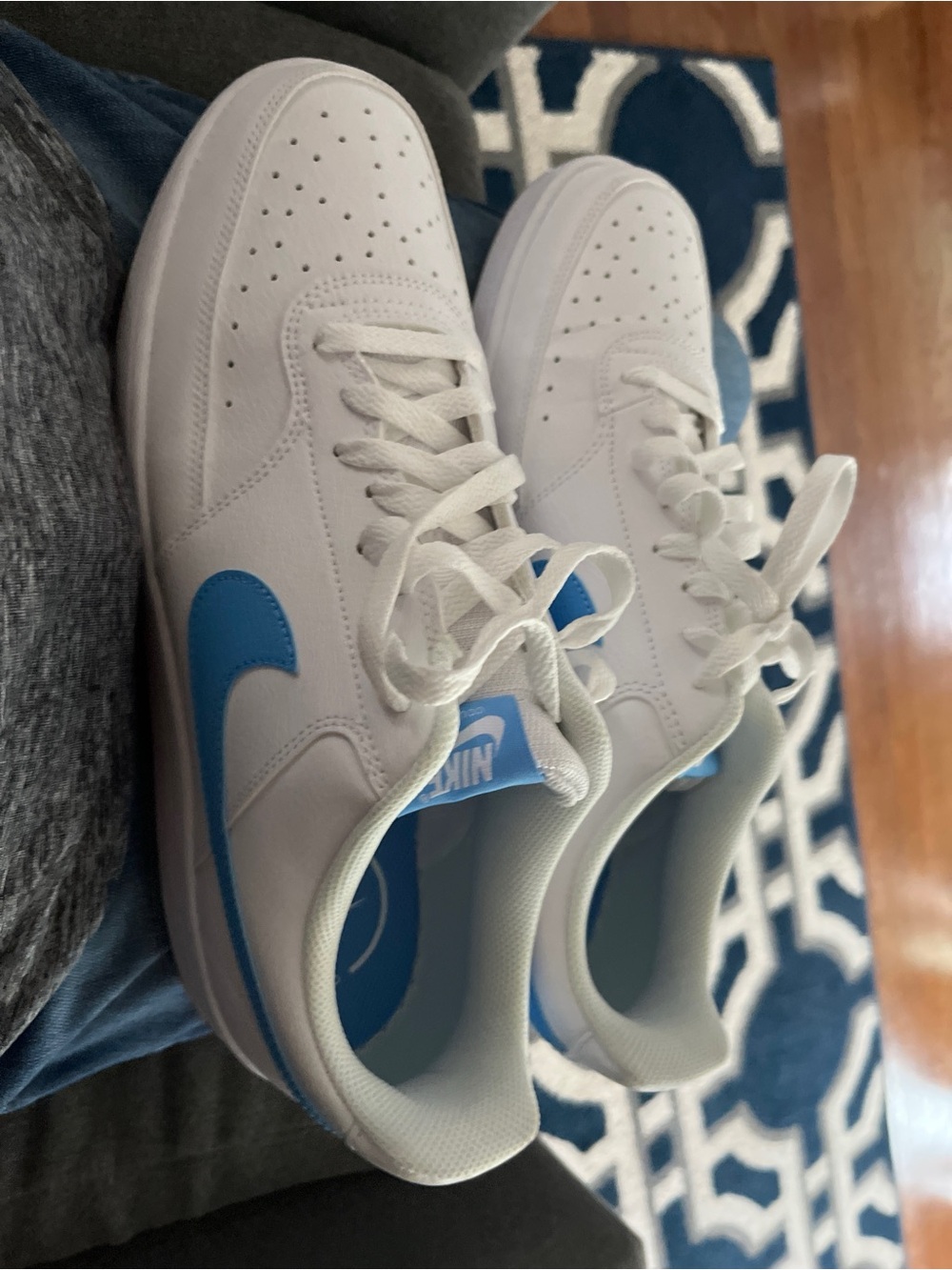 Nike Men’s White Leather Sneakers with Blue Swoosh Accent